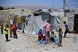 In this Monday, April 23, 2018 photo, Syrian refugee children play outside their family tents at a Syrian refugee camp in the town of Bar Elias, in Lebanon's Bekaa Valley. (AP Photo/Bilal Hussein)
